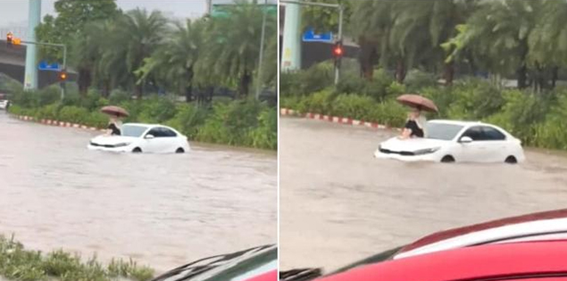 Ung dung ngồi trên nắp capo ô tô giữa "biển nước" ở Hà Nội, nữ tài xế lý giải nguyên nhân

